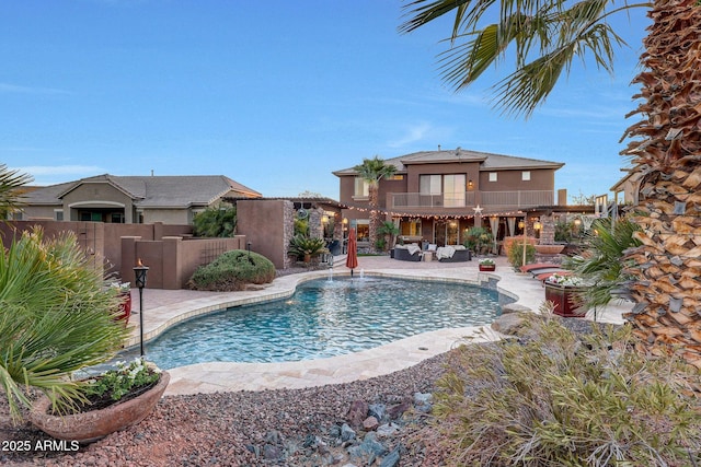 view of pool with an outdoor living space and a patio area