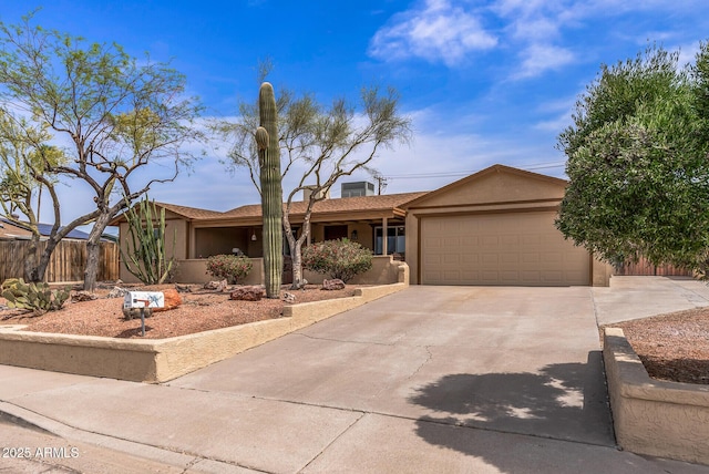 single story home with fence, driveway, stucco siding, and an attached garage