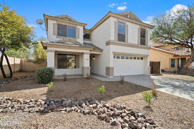 view of front of home featuring an attached garage, fence, concrete driveway, and stucco siding