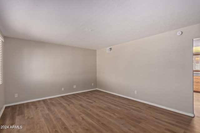 spare room with dark hardwood / wood-style floors