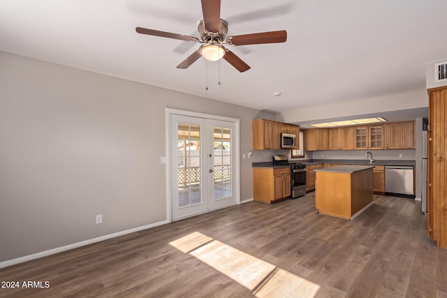 kitchen with a center island, dark wood-type flooring, stainless steel appliances, and french doors