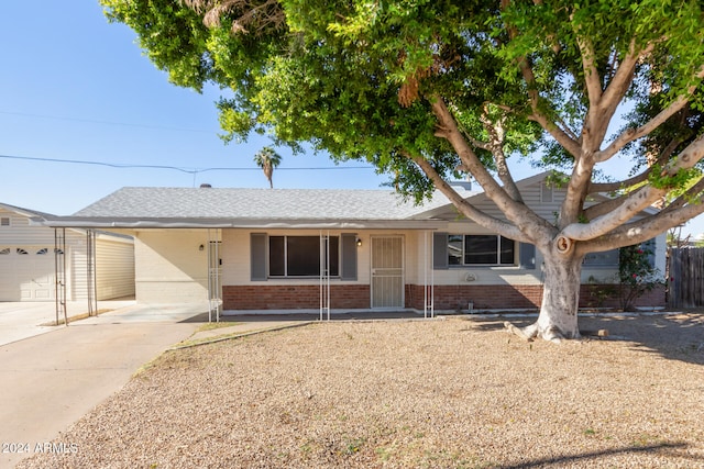 single story home featuring a garage and a carport