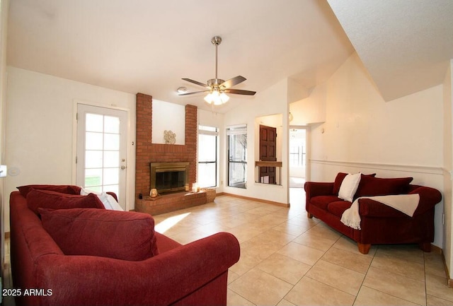 tiled living room with ceiling fan, a fireplace, and lofted ceiling