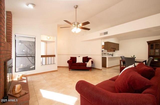 living room featuring ceiling fan, lofted ceiling, and a brick fireplace