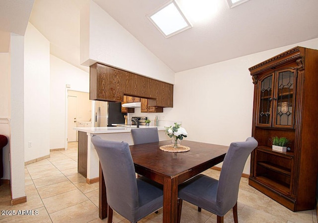 tiled dining area with high vaulted ceiling