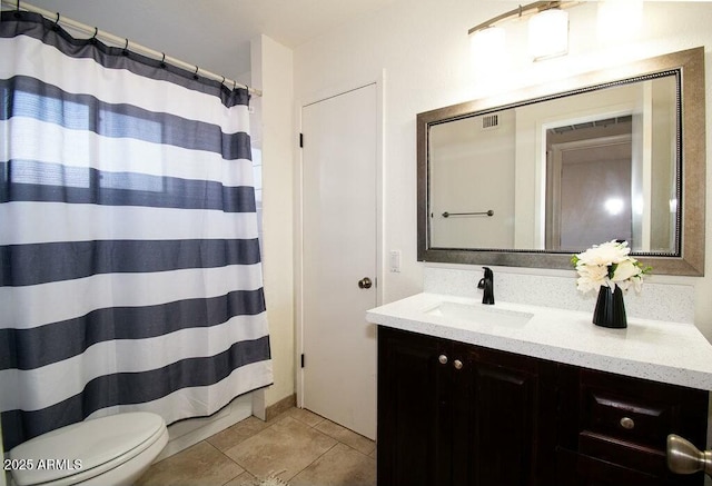 bathroom with toilet, vanity, and curtained shower