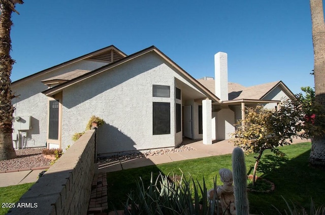 rear view of property with a yard