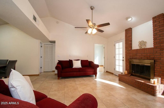 living room featuring lofted ceiling, light tile patterned floors, ceiling fan, and a brick fireplace