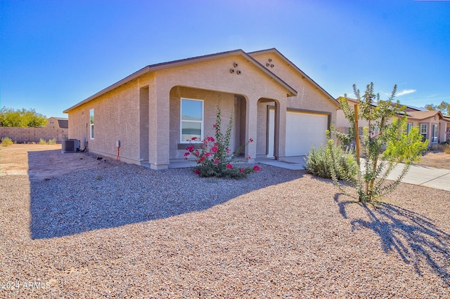 view of front of property featuring cooling unit and a garage