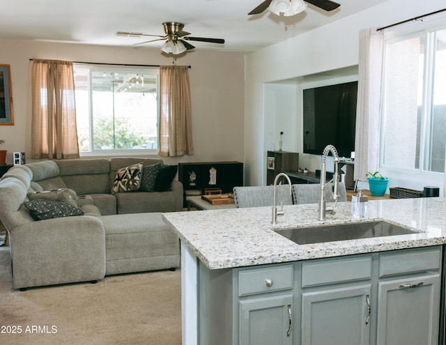 living room with light carpet and a ceiling fan