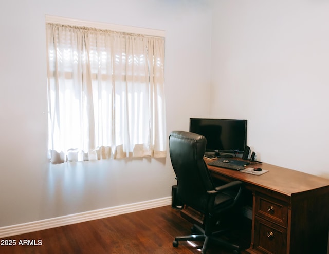 office space featuring baseboards and dark wood-type flooring