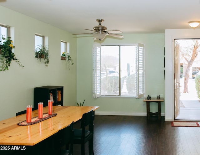 dining area featuring a ceiling fan, dark wood-style floors, and baseboards