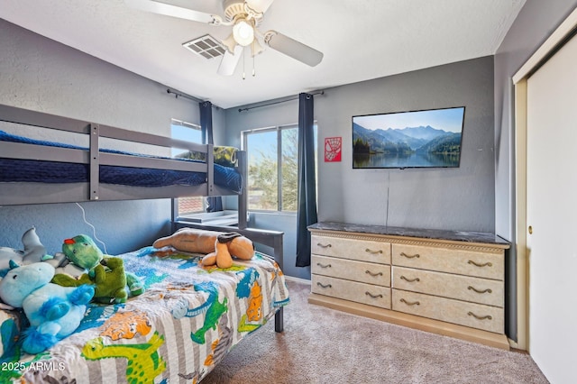 bedroom featuring light carpet and ceiling fan