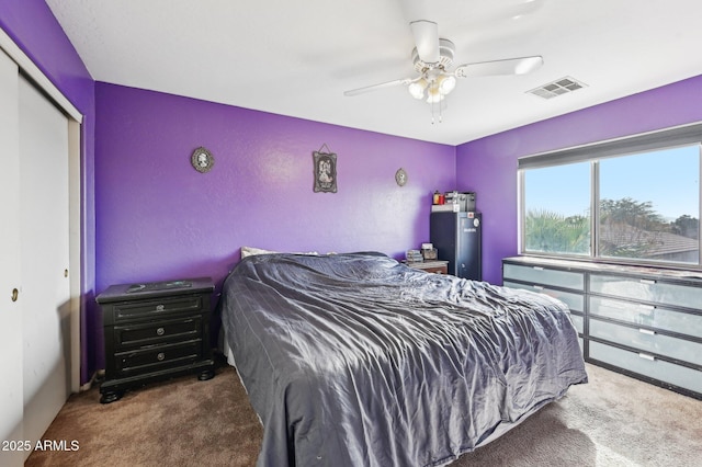 bedroom featuring a closet, ceiling fan, and carpet flooring