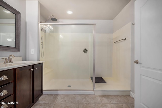 full bathroom featuring tile patterned floors, vanity, and a shower stall