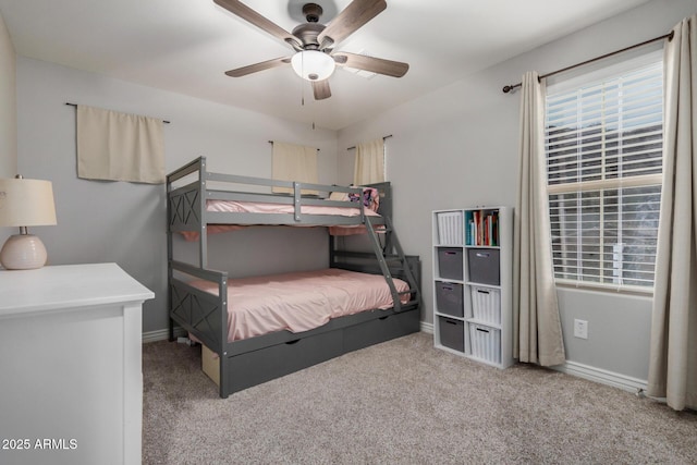 carpeted bedroom featuring baseboards and ceiling fan