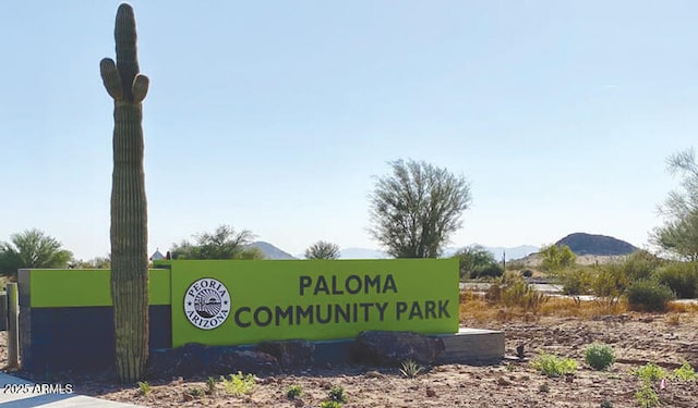 community / neighborhood sign with a mountain view