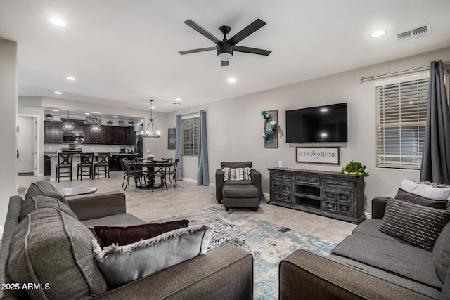 living area featuring recessed lighting, visible vents, and ceiling fan