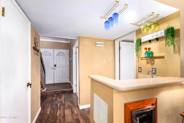 3377 W Grandview Rd, Phoenix, AZ 85053 - hallway featuring beverage cooler, baseboards, visible vents, and dark wood-style floors