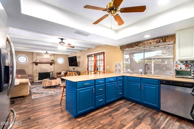 3377 W Grandview Rd, Phoenix, AZ 85053 - kitchen with appliances with stainless steel finishes, a sink, blue cabinetry, a ceiling fan, and dark wood-type flooring