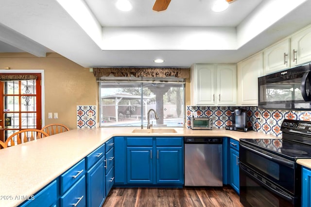 3377 W Grandview Rd, Phoenix, AZ 85053 - kitchen with blue cabinetry, a sink, black appliances, and a tray ceiling