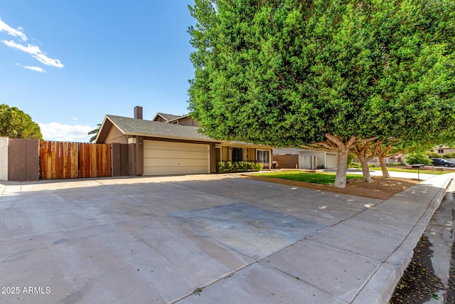 3377 W Grandview Rd, Phoenix, AZ 85053 - view of front of house with fence, stucco siding, a chimney, an attached garage, and driveway