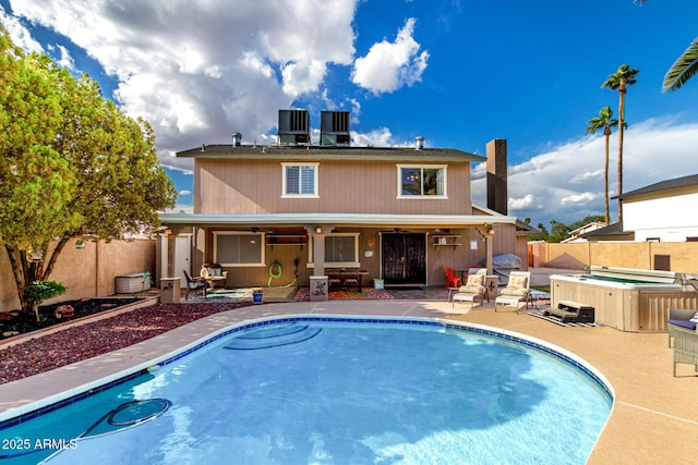 3377 W Grandview Rd, Phoenix, AZ 85053 - rear view of property with a fenced backyard, a hot tub, and a patio area