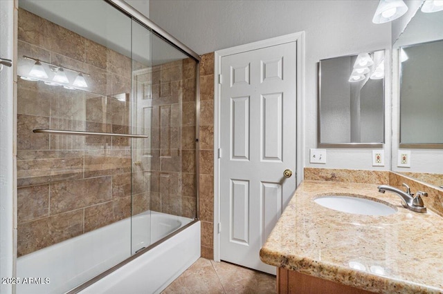 bathroom with enclosed tub / shower combo, vanity, and tile patterned floors