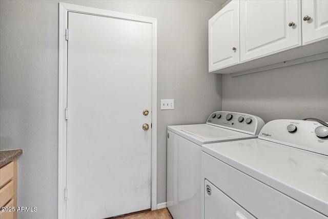 laundry room with independent washer and dryer and cabinet space