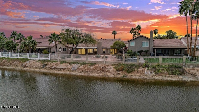 property view of water featuring a fenced front yard