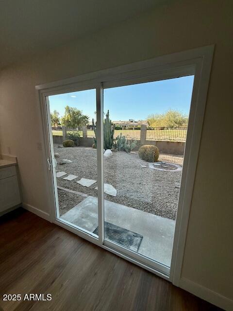 doorway to outside with dark hardwood / wood-style floors