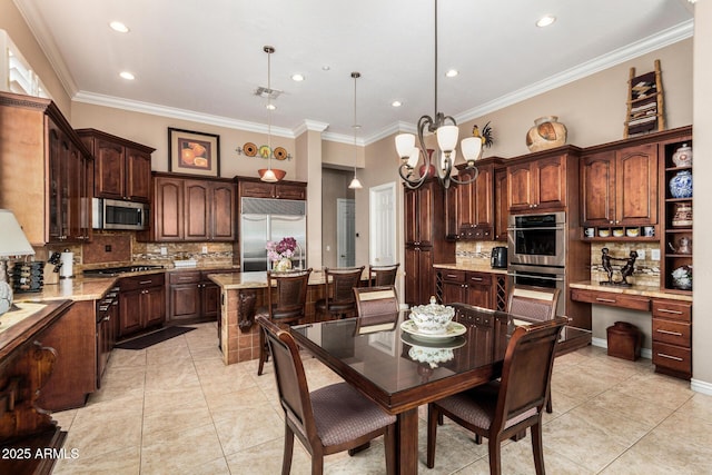 kitchen with crown molding, dark brown cabinets, a chandelier, stainless steel appliances, and tasteful backsplash