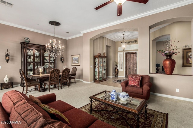 carpeted living room with visible vents, arched walkways, baseboards, and ceiling fan with notable chandelier