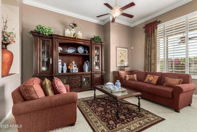 carpeted living room featuring a ceiling fan, baseboards, and ornamental molding