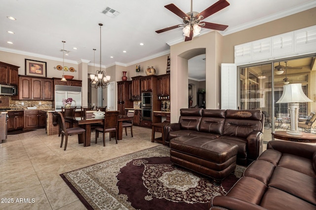 living room featuring visible vents, arched walkways, ceiling fan with notable chandelier, ornamental molding, and recessed lighting