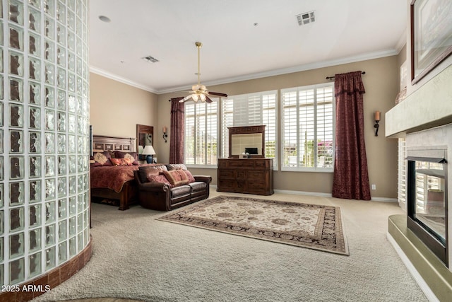 carpeted living room with visible vents, ornamental molding, ceiling fan, and a fireplace