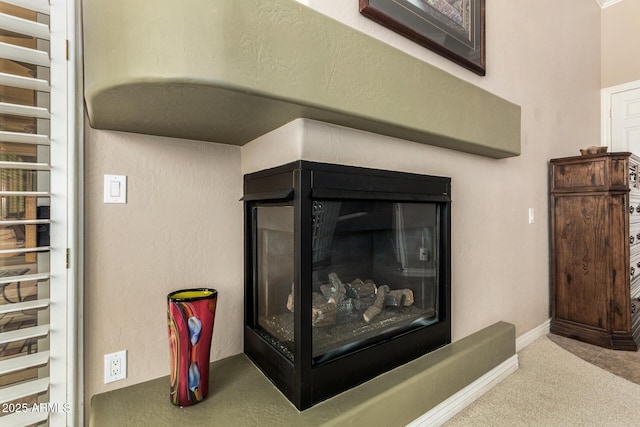 room details with carpet flooring, baseboards, and radiator heating unit