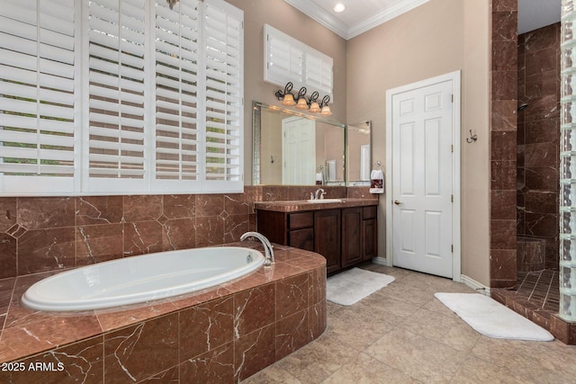 bathroom featuring plenty of natural light, vanity, ornamental molding, and a bath