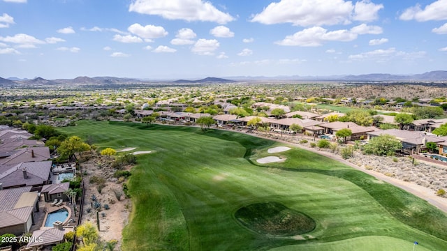 drone / aerial view featuring view of golf course, a residential view, and a mountain view
