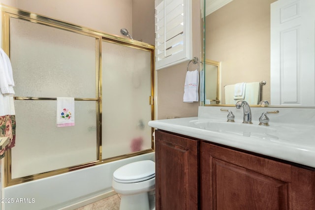 full bathroom featuring vanity, combined bath / shower with glass door, and toilet