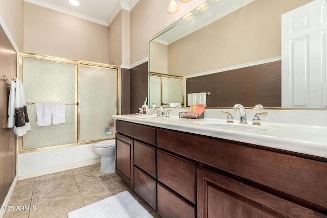 bathroom with double vanity, ornamental molding, toilet, a sink, and enclosed tub / shower combo