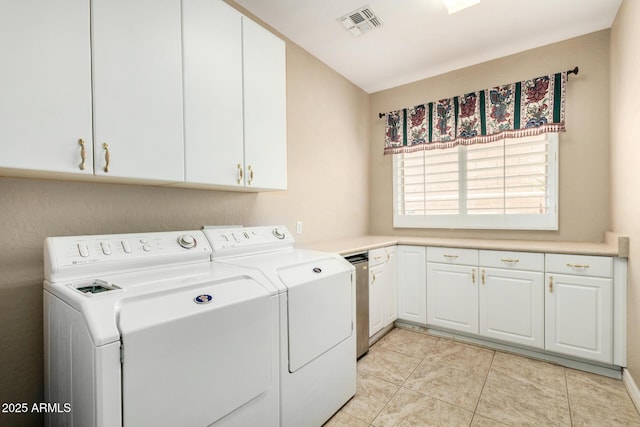 washroom with visible vents, cabinet space, light tile patterned floors, and washer and dryer