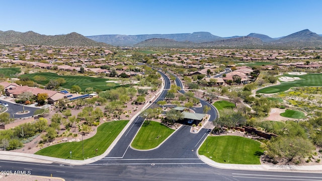 drone / aerial view with a residential view, a mountain view, and golf course view