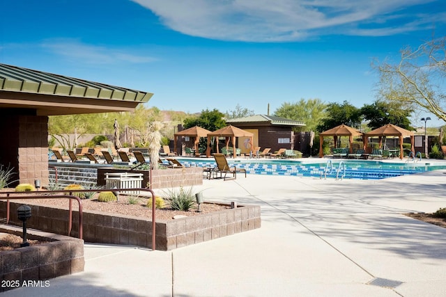 community pool with a gazebo and a patio