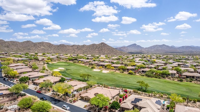 drone / aerial view featuring a residential view, a mountain view, and golf course view