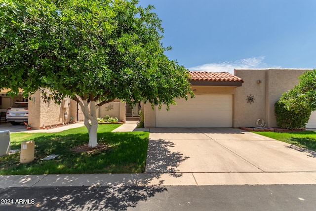 view of front of house with a garage and a front yard