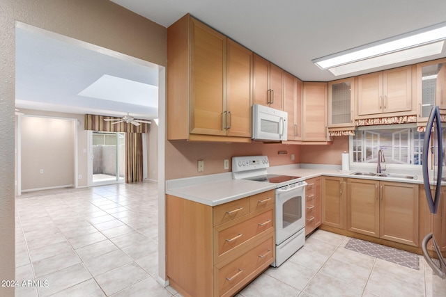 kitchen with light tile patterned flooring, white appliances, ceiling fan, and sink