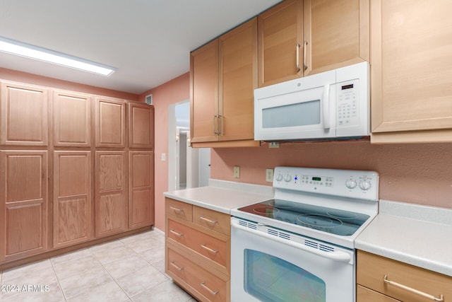 kitchen with light tile patterned floors and white appliances