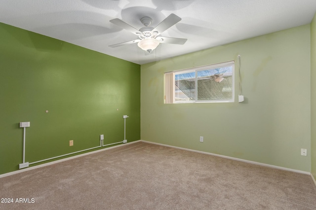 empty room featuring light carpet and ceiling fan