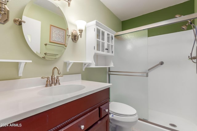 bathroom featuring vanity, toilet, and walk in shower